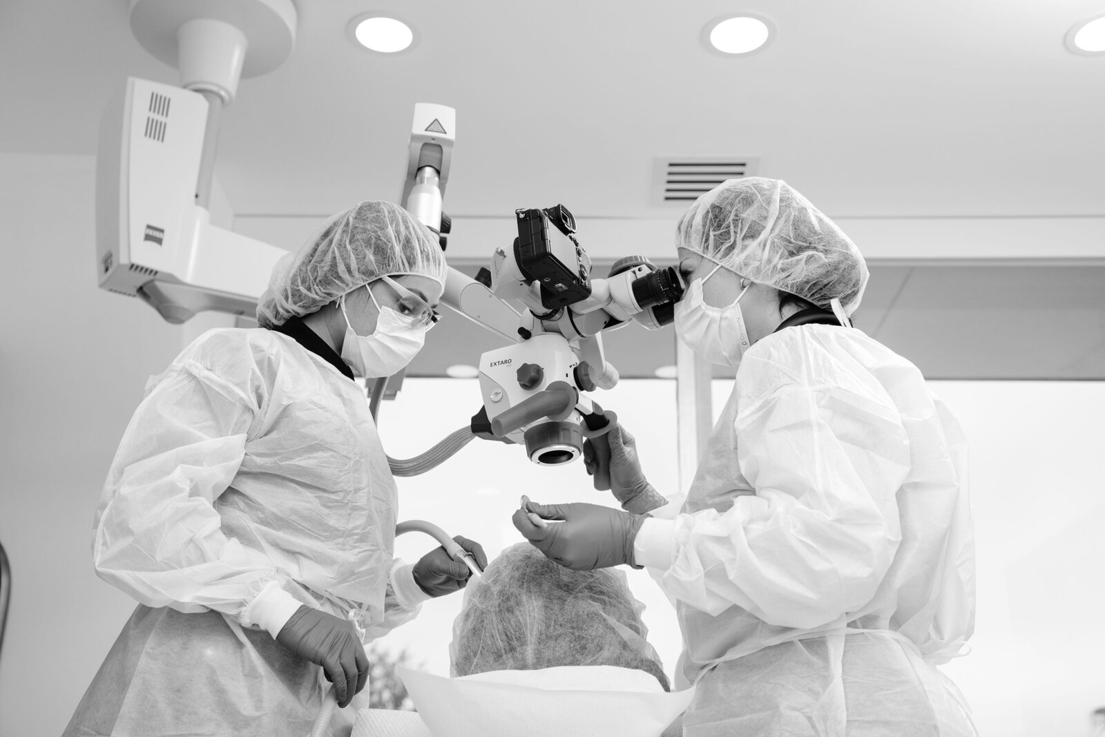 ELEV8's holistic dentists treating a patient under a surgical microscope in Beverly Hills