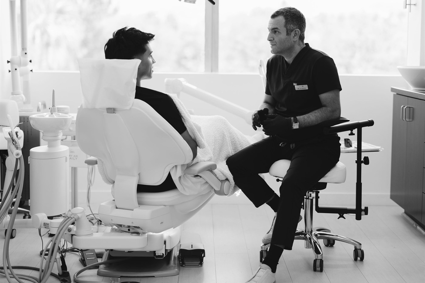 Dr. Rashad Riman consulting with a patient at ELEV8 Biological Dentistry in Beverly Hills